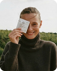 A girl smiling and holding persona packs